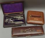 A 19th century part drawing set, some of the steel instruments with ivory handles within a walnut