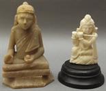 An Indian small carved ivory deity of a god playing the flute and a soapstone seated buddha.