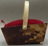 A 19th century rectangular tapered pin cushion in the form of a basket with an ivory swing handle,