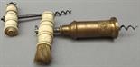 A Thomason pattern double-action corkscrew with a turned bone handle with brush and one other bone