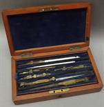 A 19th century drawing set by Elliott with a tray of brass instruments within a mahogany box.