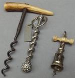 A miniature steel spring loaded corkscrew, a corkscrew with antler handle, and one other corkscrew.