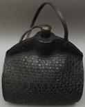 An 18th or 19th century leather costrel with tooled basketwork, of barrel form with stitched