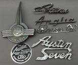 Six various car badges to include an Austin Seven and Rover 90.