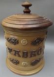 A French salt glazed tobacco jar with turned wood cover, the sides with applied decoration and "