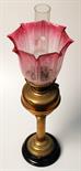 A brass fluted column oil lamp with brass font and etched cranberry glass shade. Condition Report: