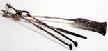 A set of three good George III steel fire implements with urn finials, axehead shaped shovel and