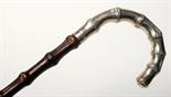 A bamboo walking stick by Swaine & Adeney the silver handle simulating bamboo, hallmarked for London