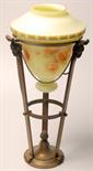 A circular tapering brass lamp stand, the three arms with rams head mounts and tail swags,