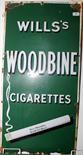 A 'Will's Woodbines cigarettes' enamel advertising sign on green ground, 91 x 46m, together with