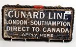 A 'Cunard Line London-Southampton Direct to Canada' metal advertising sign mounted on a wooden