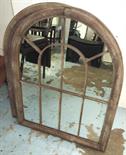 MIRRORS, a pair, with a domed top in metal frames, 88cm x 69cm. (2)