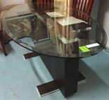 DINING TABLE, the oval glass top on a rectangular pedestal base with polished metal detail, 180cm