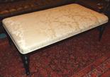 STOOL, Regency style ebonised with cream damask upholstery, 140cm x 80cm.