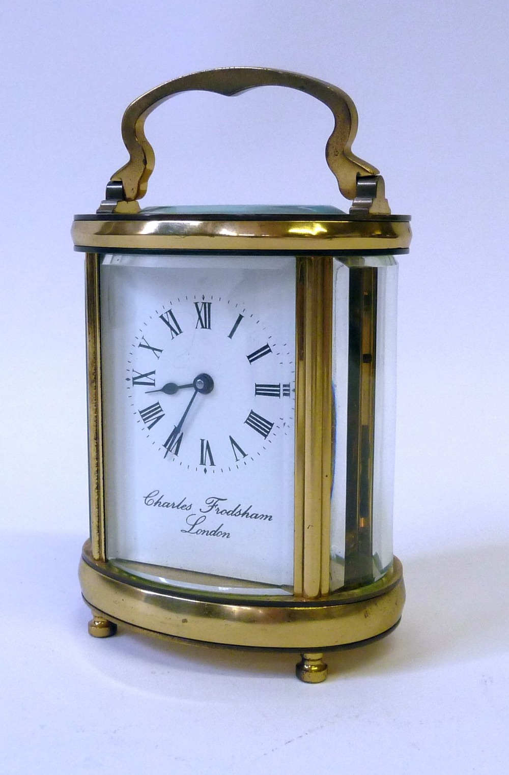 CHARLES FRODSHAM, LONDON GILT BRASS OVAL CARRIAGE CLOCK, with shaped