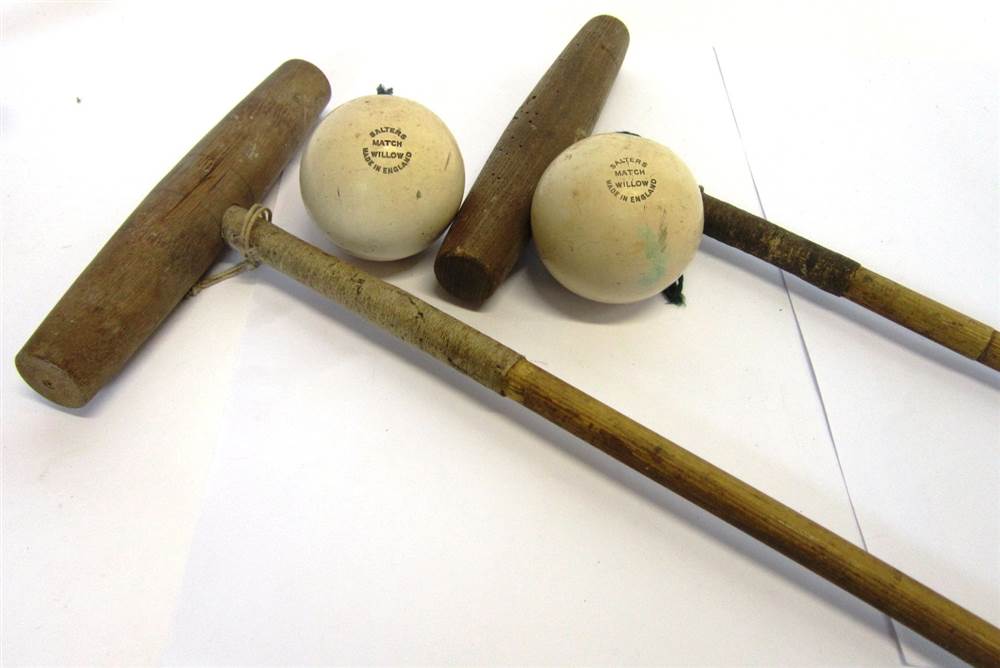 TWO POLO MALLETS With bamboo shafts and leather grips, and a pair of