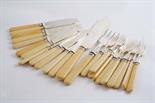 A MODERN SET OF TWELVE FISH KNIVES & ELEVEN FISH FORKS with ivory handles and a pair of matching