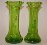 A pair of green glass vases with folded rims