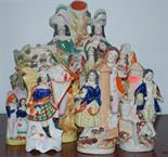 A collection of principally Victorian Staffordshire figures to include; spill holder and bocage