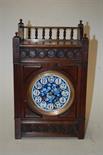 A late Victorian Aesthetic Movement walnut cased mantel clock, with painted enamel dial and French