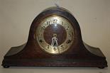 An oak cased striking and chiming mantel clock