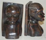 A pair of African carved hardwood book-ends in the form of male and female busts