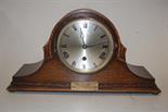 An oak cased striking and chiming mantel clock