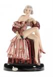 A GOLDSCHEIDER FIGURE OF A YOUNG WOMAN MODELLED BY STEFAN DAKONseated on a draped plinth in pink