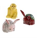 THREE BERNARD MOORE ANIMALScomprising a seated monkey in bright yellow glaze and two rabbits, one