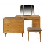 A HEAL`S SATIN WALNUT BEDROOM SUITE DESIGNED BY ALFRED COXcomprising wardrobe, chest of drawers