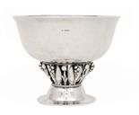 A GEORG JENSEN SILVER BOWLwith gently rounded sides flared at the rim and hammer textured, supported