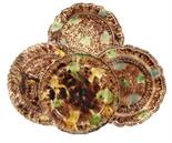 THREE CREAMWARE PLATES AND A SOUP PLATE in coloured glazes with feather or other rim, sponged in
