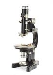A Leitz black enamelled Petrological Microscope, with three eyepieces, five objectives and