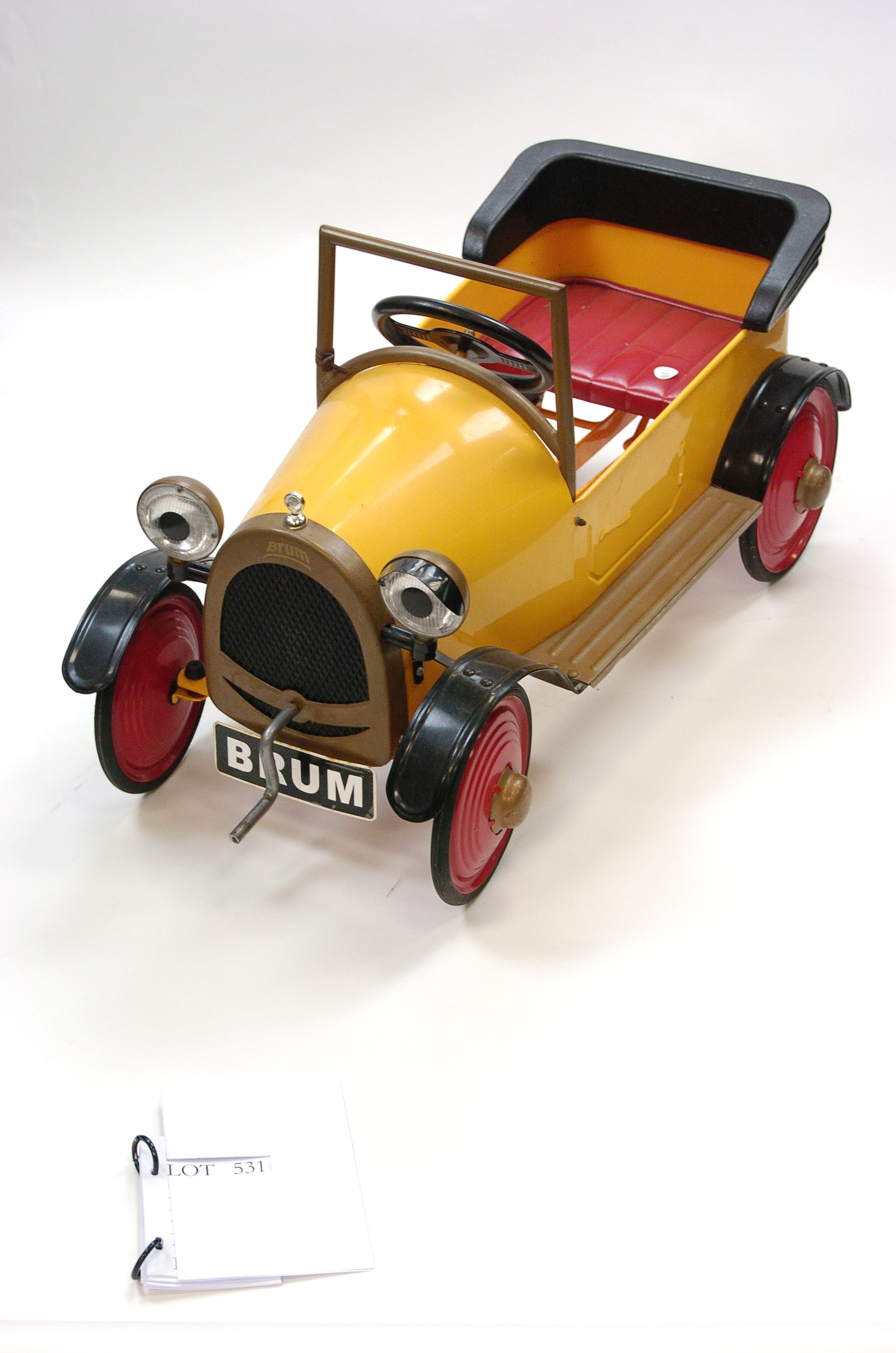 A Brumm Pedal Car In Yellow With Gold And Black Trim Red Wheels And Seat G One Headlamp Lack