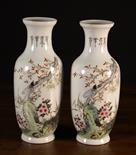 A Pair of Chinese Republican Vases decorated with rockwork, insects, tree boughs and blossom on a