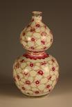 A Fine Chinese Double Gourd Vase Decorated with Pink Blossoms on an ivory ground, bearing a Qianlong