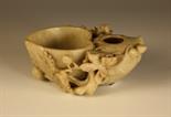 A Chinese Soapstone Brush Pot carved in the form of a hollowed peach nestled on a bough of