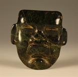 A Carved Spinach Jade Face Mask, 5 ins x 4½ ins (13 cms x 10 cms).