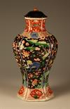 A Kang Hsi Vase of flattened baluster form.  The serpentine moulded side panels painted in