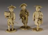 Three Small Japanese Ivory Carvings of men stood on round bases signed underneath, approx. 3¼ ins (8