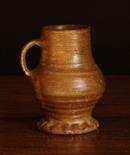 A Medieval Raeren Mug, circa 15th century.  The ring turned bulbous body on a thumb crimped foot, 6¼