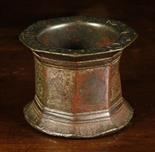 A 13th Century Bronze Mortar of octagonal form with flared rim and foot.  The sides finely