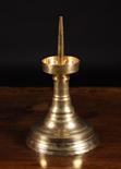 A Large Gothic Brass Pricket Stick.  The spike centring a ring-turned drip pan with upright sides on