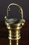 A 16th Century Flemish Bronze Holy Water Stoup with a shaped handle and face mask protrusions. 6¾