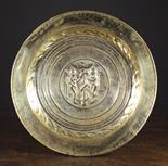 A Fine 16th Century Nuremberg Brass Repoussé Alms Dish.  The centre panel depicting Adam & Eve