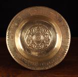 A 16th Century Nuremberg Brass Alms Dish, 16 ins (41 cms) in diameter.