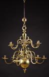 An 18th Century Brass Twelve Branch Chandelier.  The crested S-scroll candle arms morticed and