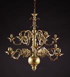 A 17th Century  German Twelve Branch Bronze Chandelier. The scrolling candle arms set in two tiers