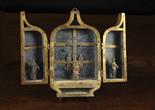 A Small 17th Century Glazed Triptych Box composed of sheet metal.  The Gothic arch-topped doors