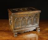 A 19th Century Oak Casket on shaped sledge feet, decorated with carved tracery arches and centred by